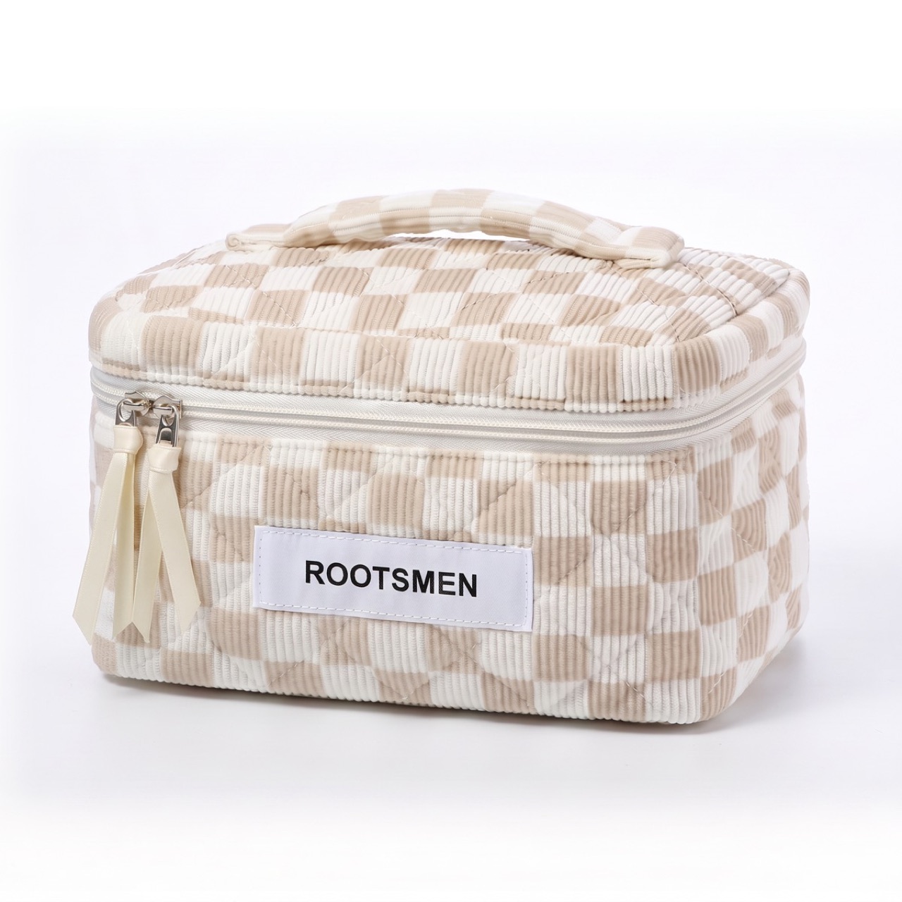 A structured vanity case standing open on a counter, its rigid base and lid holding their shape, with a removable tray lifted out beside it.